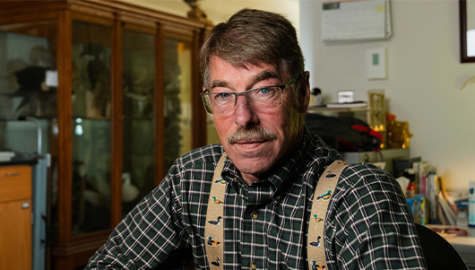 Peter Saenger sits at a desk in the Acopian Center.