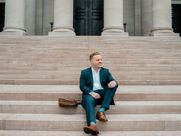 student sits on court house steps