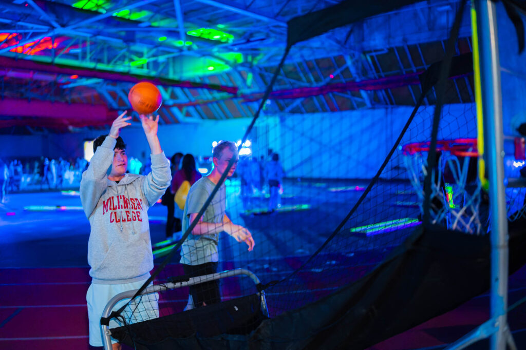 A Muhlenberg College student plays an arcade basketball game in the field house