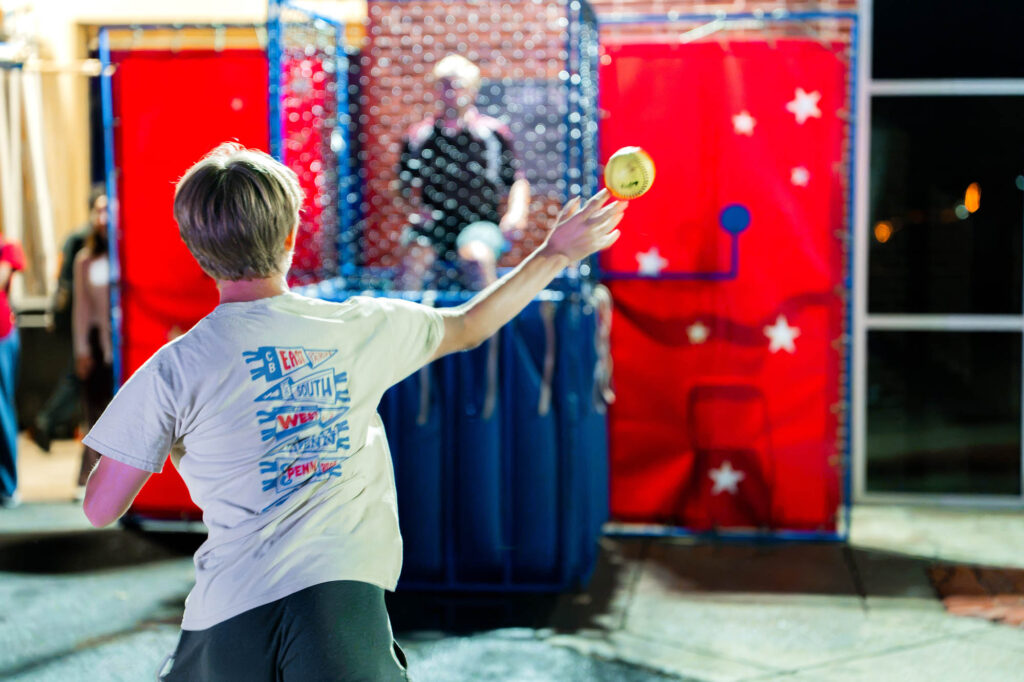 Welcome Weekend and Orientation A Muhlenberg College student throws a softball at a dunk tank