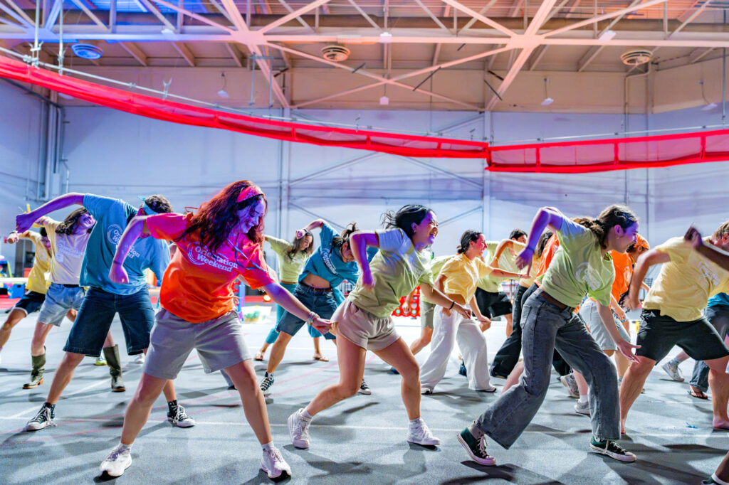 Muhlenberg College orientation leaders dance during a welcome party in the field house