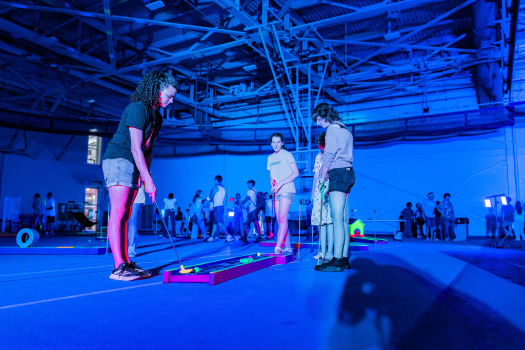New Muhlenberg College students play blacklight mini golf