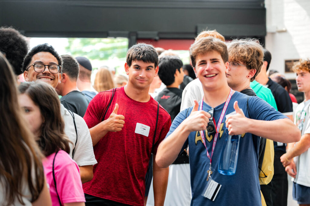 Two Muhlenberg College students give the thumbs up during orientation