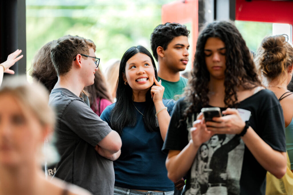 A new Muhlenberg College student smiles while talking to another student during orientation