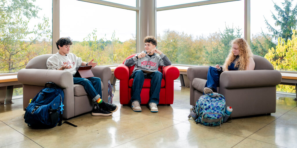 Students chat and study in student housing as part of life on campus