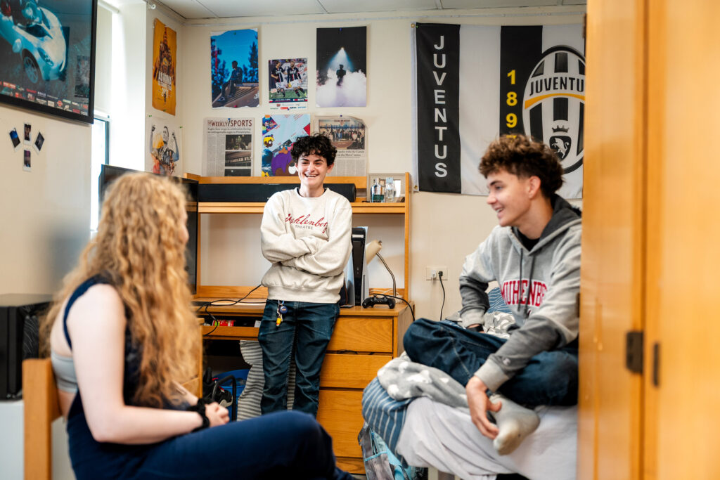 Students chat in student housing as part of life on campus