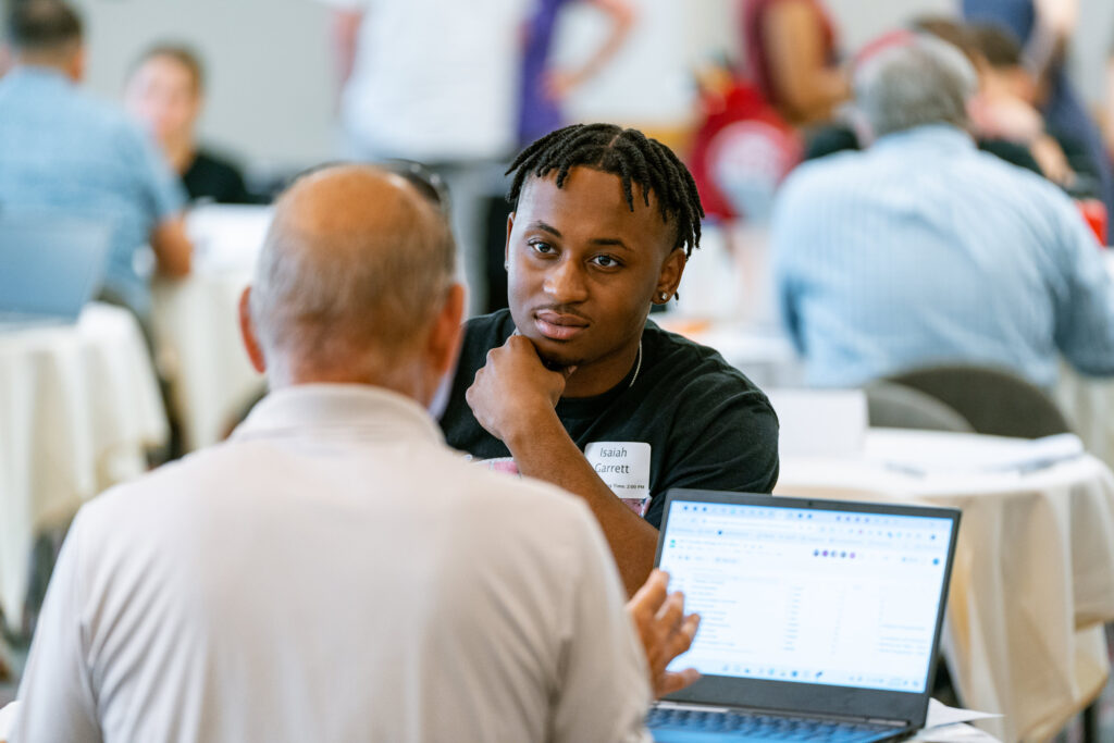 A college student speaks with his academic advisor