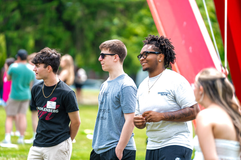A group of admitted Muhlenberg students gather on the campus green.