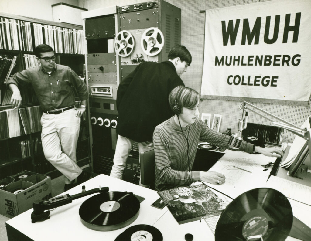 A black and white archival photo of students working in the WMUH station