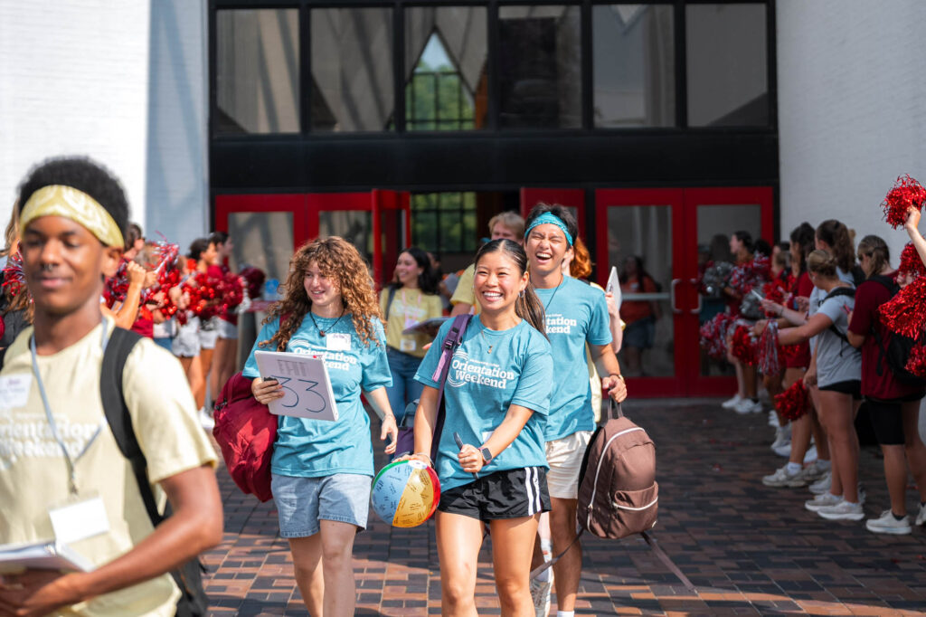 Muhlenberg College orientation leaders leave a building