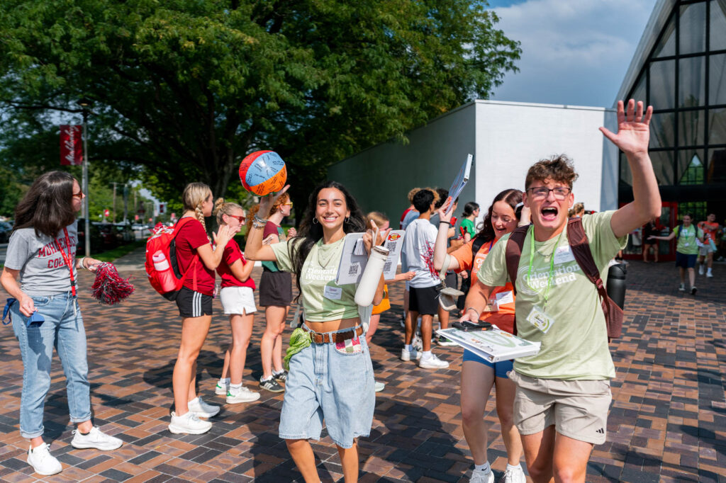 Muhlenberg College orientation leaders exit the student welcome while cheering