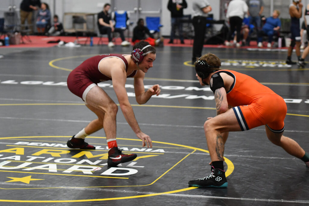 Two college wrestlers compete on a mat