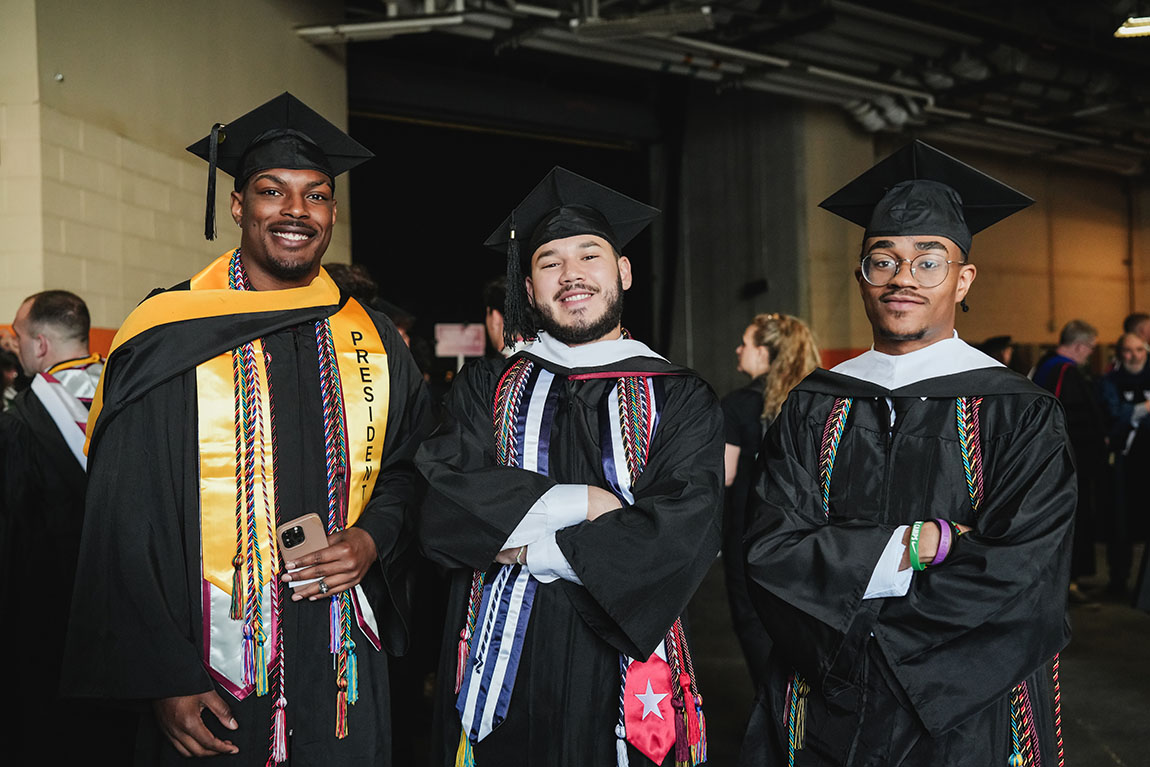 College students pose for a photo before their commencement ceremony.